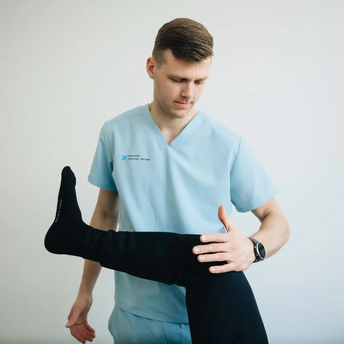 Therapist rehabilitating a patient's knee after an ACL injury