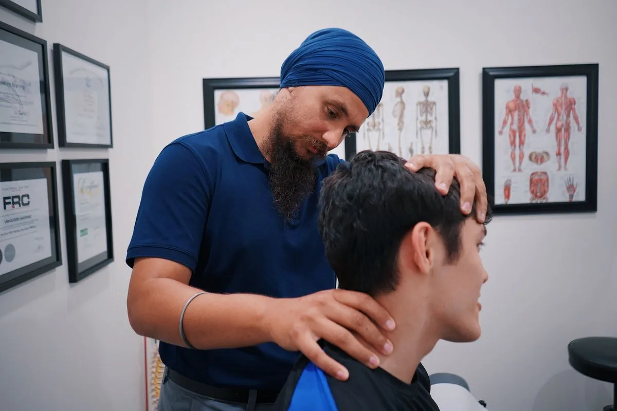 Physical therapist assessing a patient for neck pain at Ability Allies in Seacoast, NH
