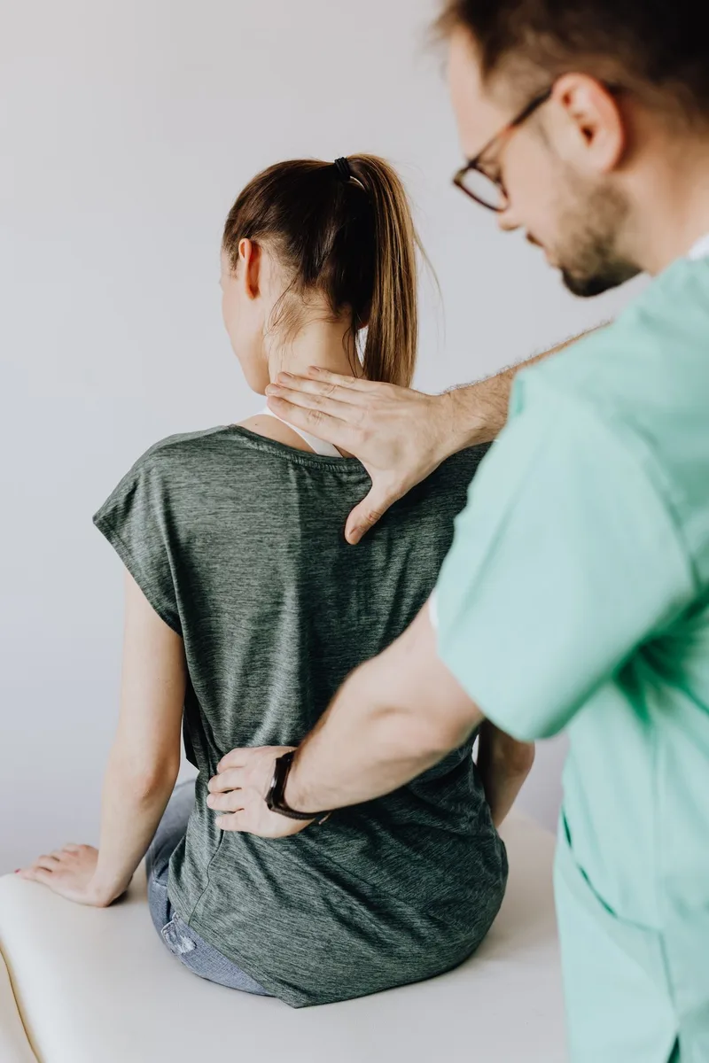 Physical therapist assessing a patient for tailbone pain at Ability Allies in Seacoast, NH