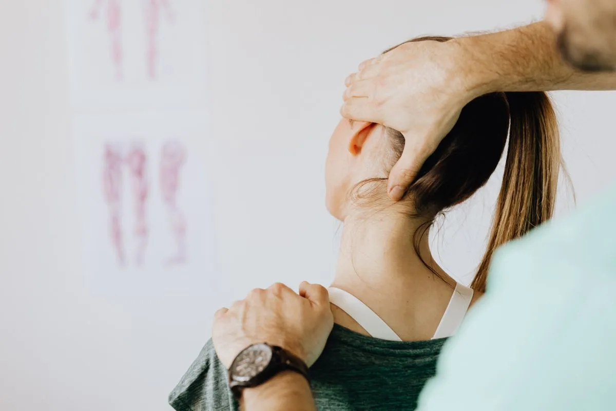Therapist assessing a patient for thoracic outlet syndrome