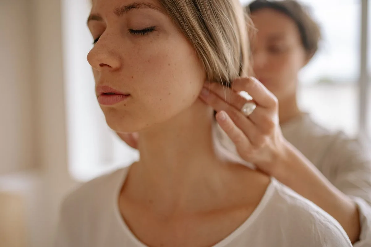 Therapist treating a patient's jaw tension and TMJ symptoms