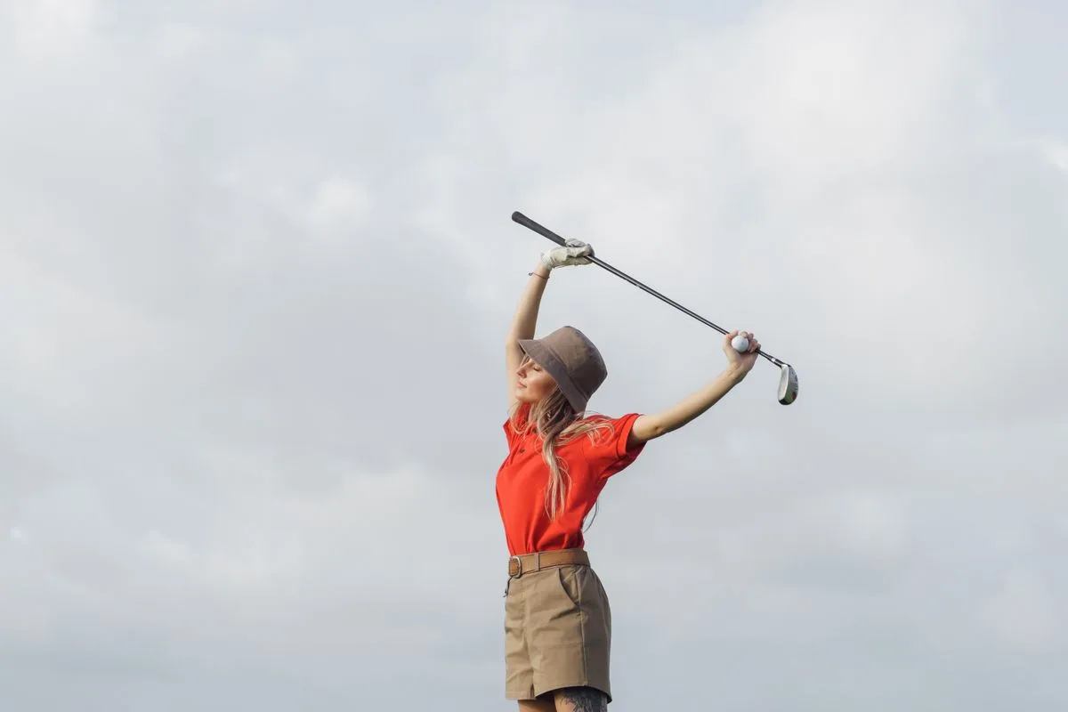 Golf injury specialist assessing a patient’s swing mechanics