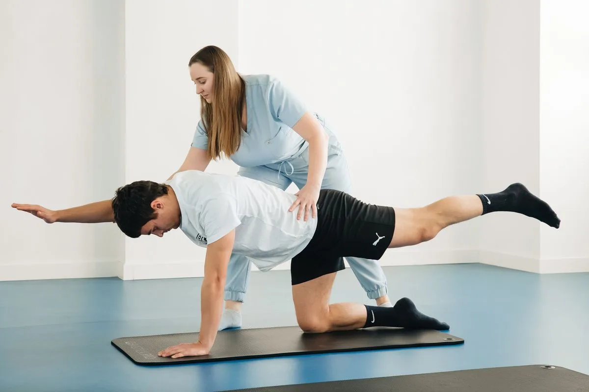 Therapist guiding a patient through pelvic floor therapy exercises