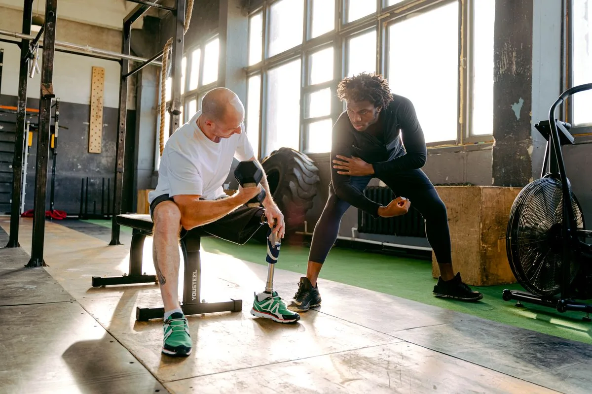 Therapist coaching a patient through strength training for return to activity